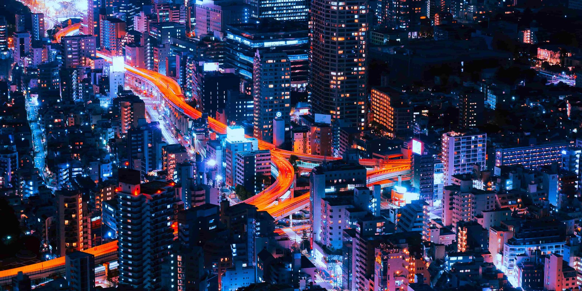 Tokyo night skyline with layered neon lights, representing how the city’s culture feels strange and intensely alive