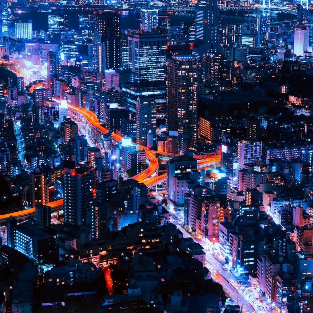 Tokyo night skyline with layered neon lights, representing how the city’s culture feels strange and intensely alive
